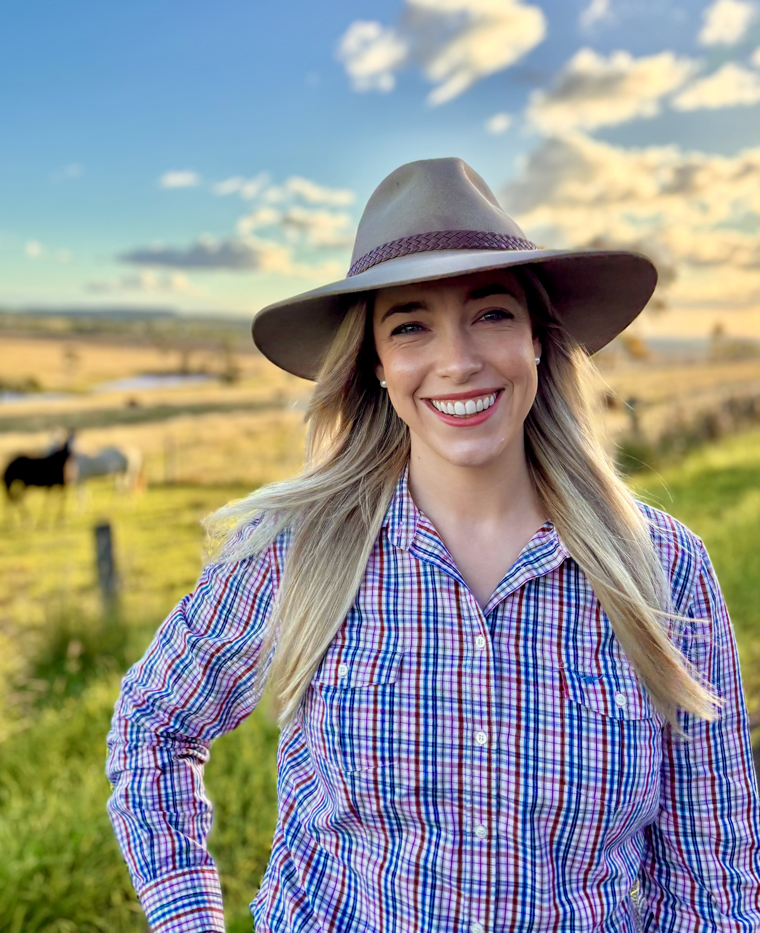 A photo of Principle Trade and Investment Officer Tahnee Odorico standing in a paddock