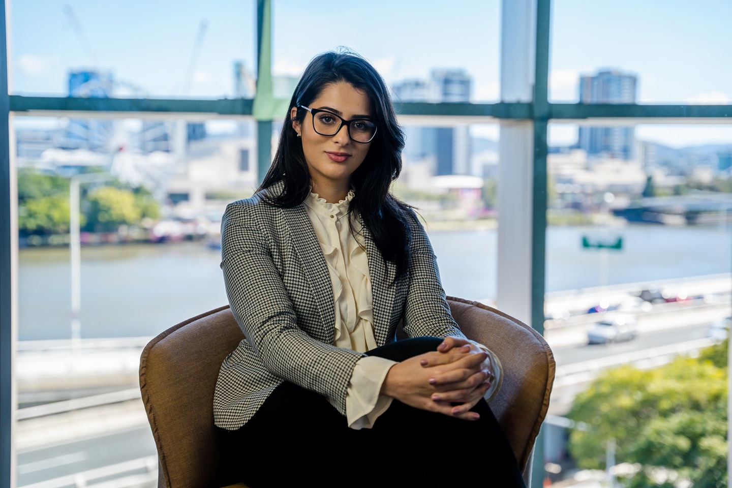 Lady sitting on chair in office.